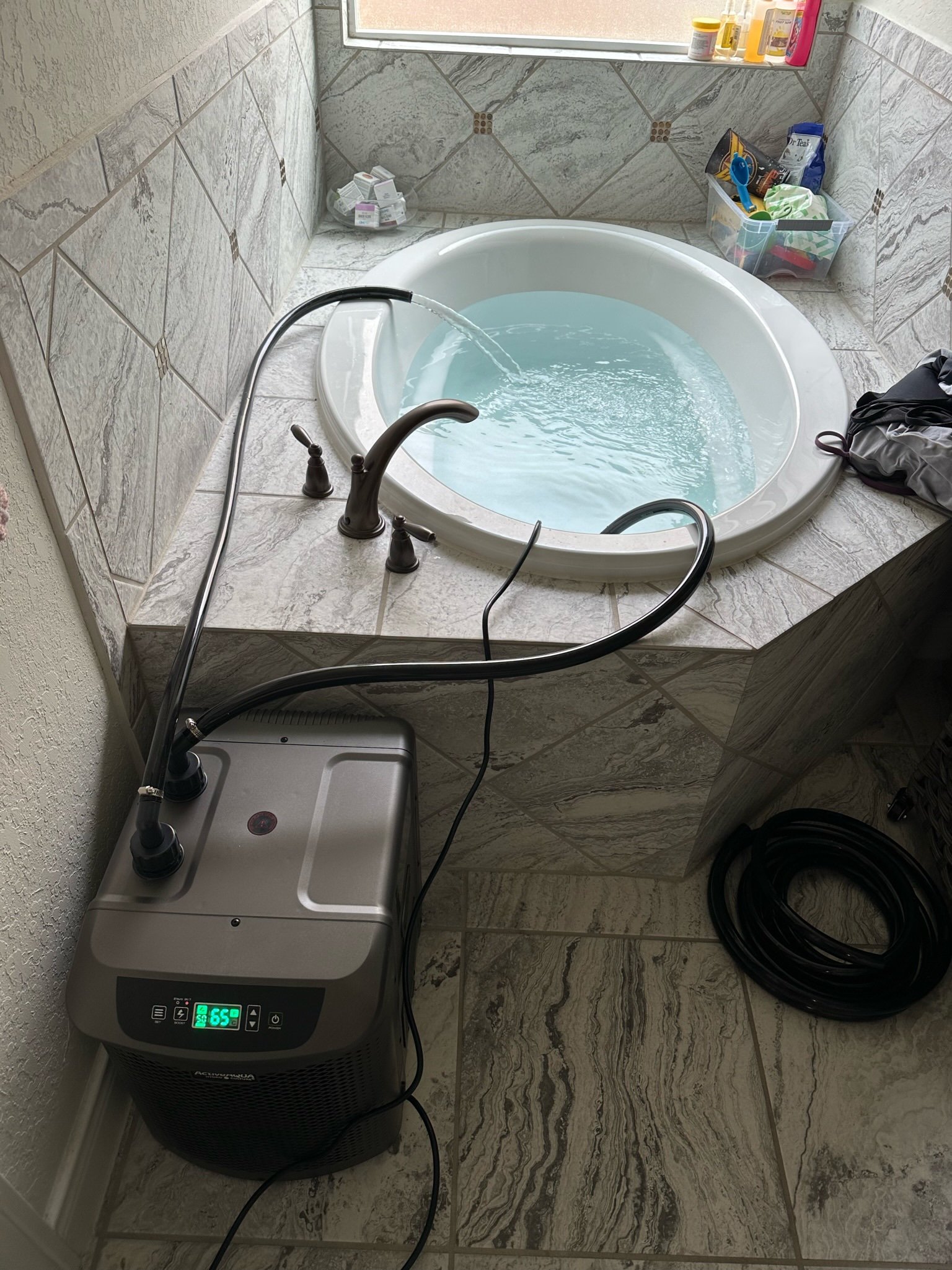 Early PlungIT experiment using a water chiller and hoses to circulate water through a household bathtub, February 19, 2023.
